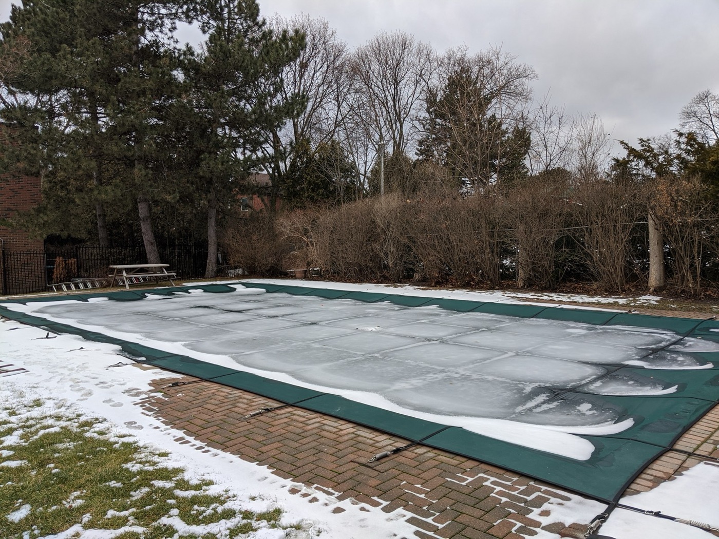 A covered pool. The cover cuts evaporation by half to seventy percent, which a lawn cannot do.
