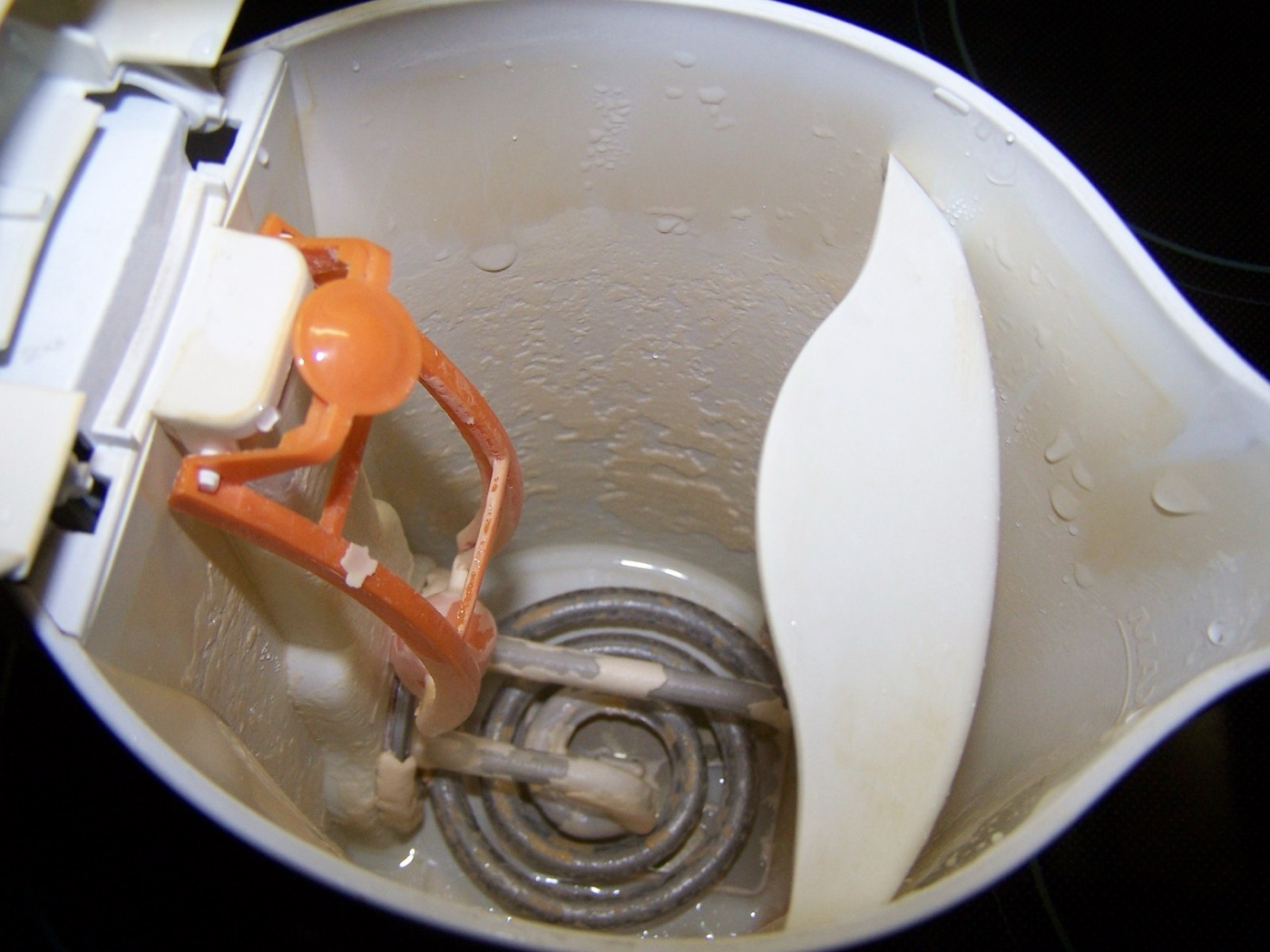 Scale on a kettle element. It is the calcium of hard water, it slows the kettle, and it is harmless.