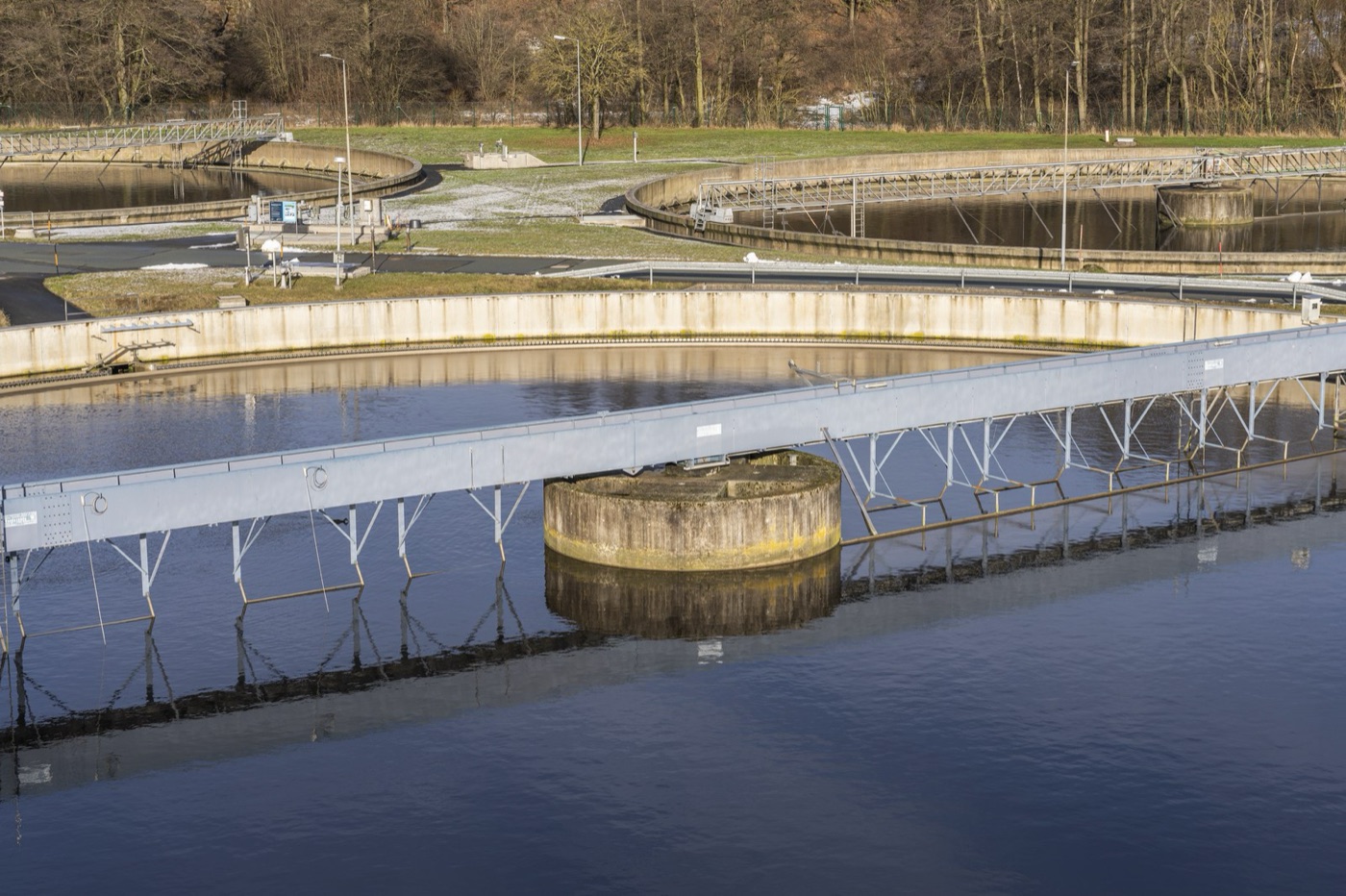 A circular clarifier. The bacteria settle here, and the clear water leaves over the weir.