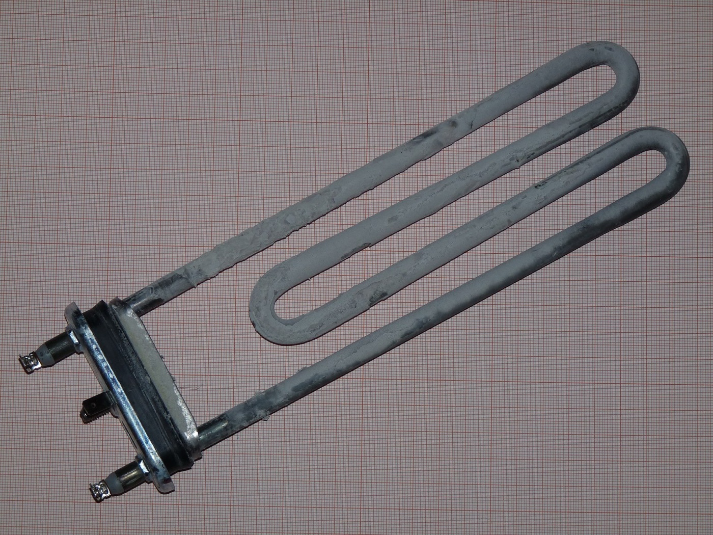 A washing machine heating element coated in scale. Hard water leaves its calcium wherever it is heated.
