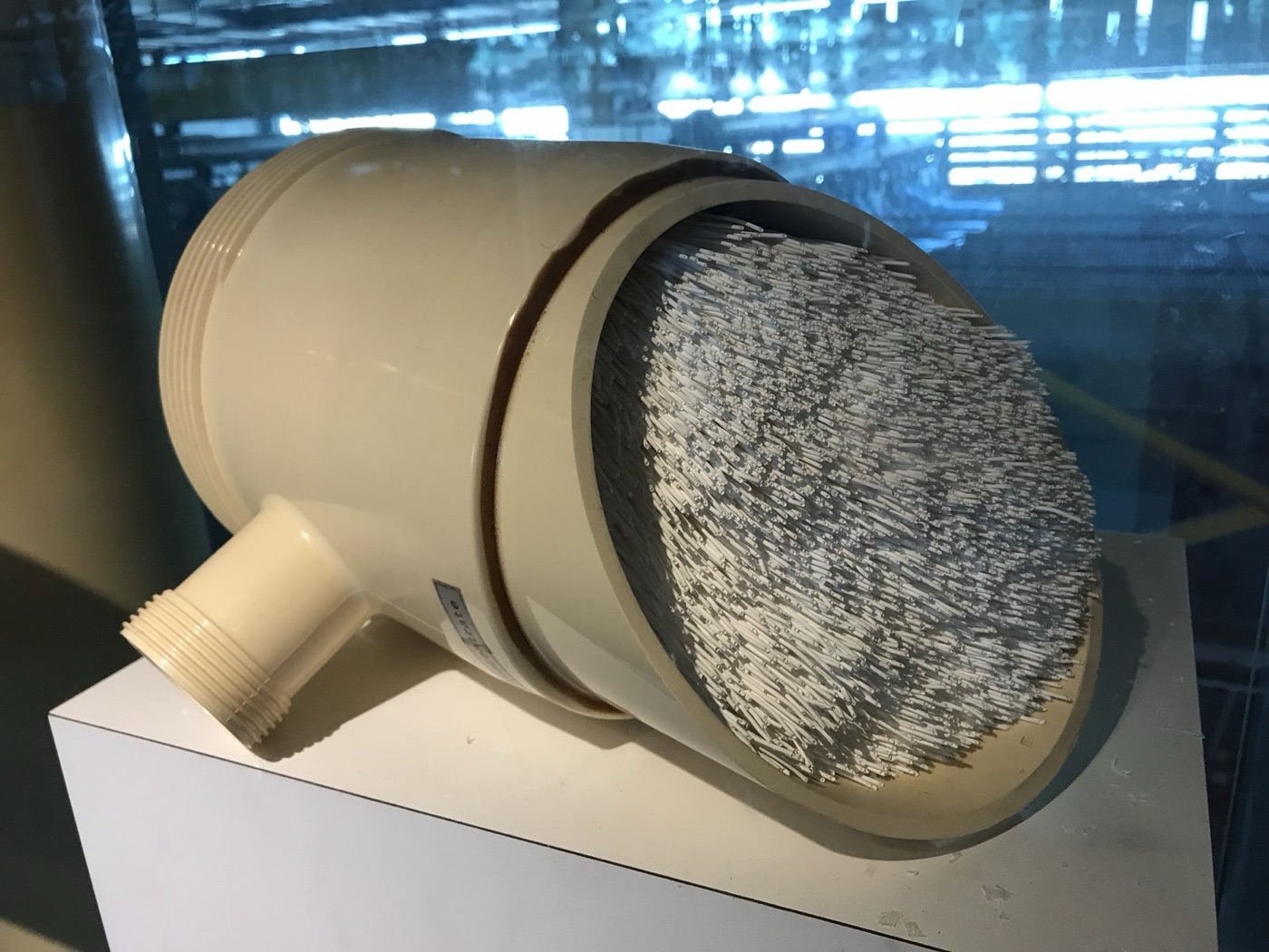 A hollow fibre module cut open: thousands of fibres, each one a tube with walls full of pores.