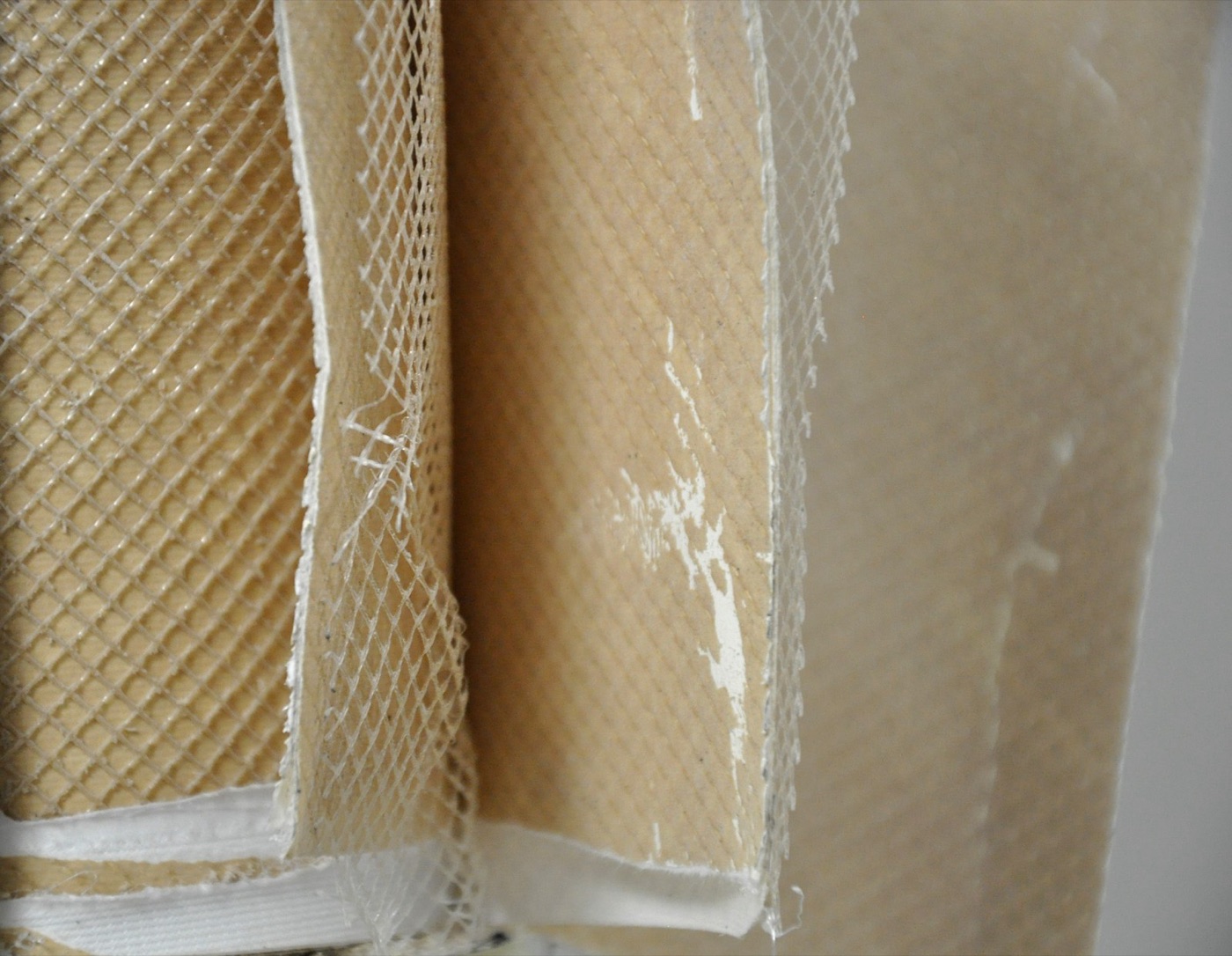 The layers of a reverse osmosis element, unrolled. The membrane itself is thinner than a hair.