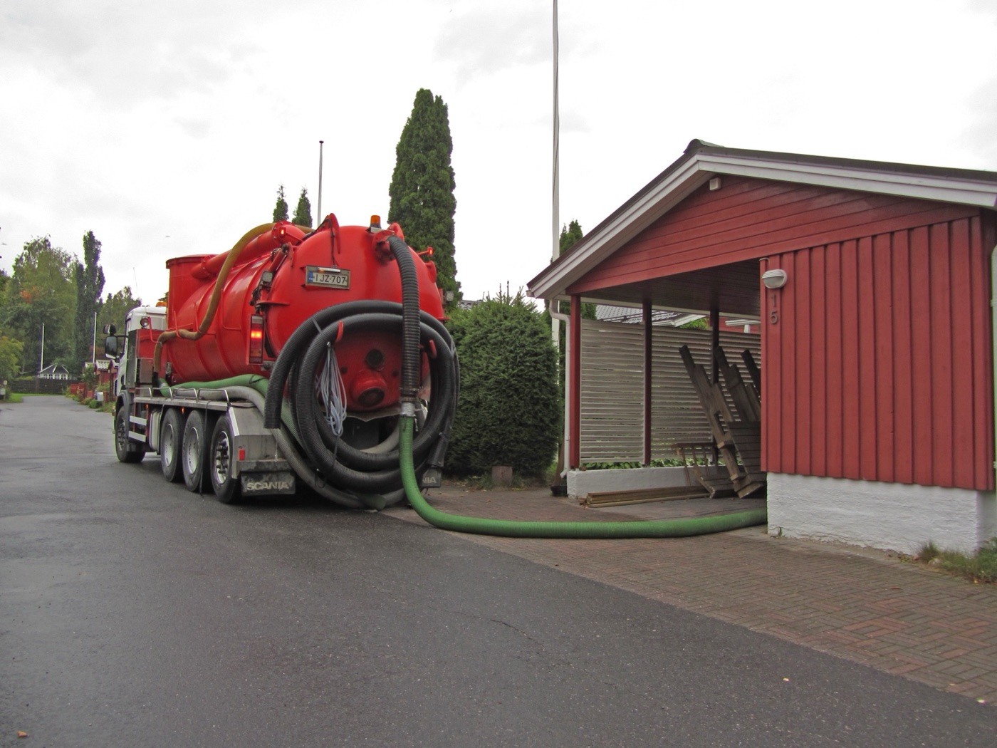 A vacuum truck at a house. Every three to five years the tank is emptied, and what the truck does with the load depends on the country.