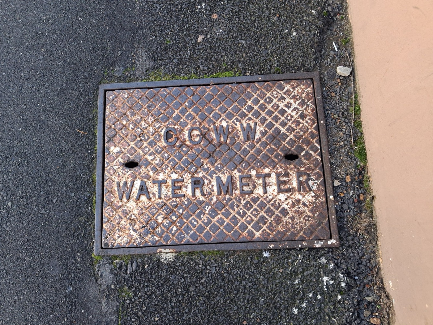 A meter cover in the pavement. Read twice a year by a person with a torch, or every hour by a radio.