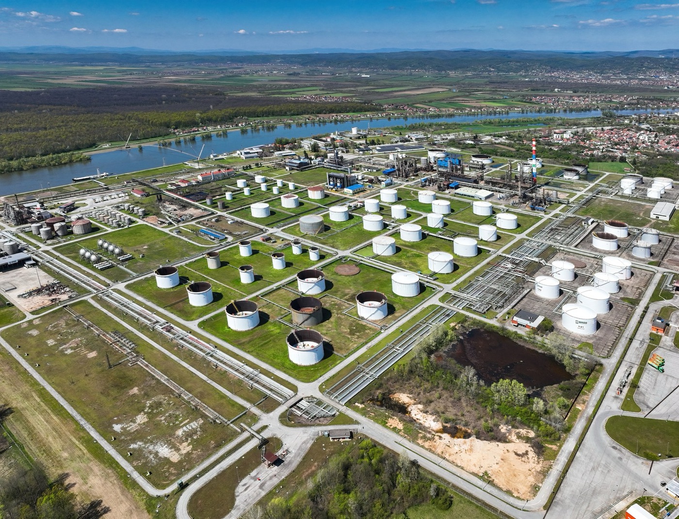 A refinery tank farm from the air. Over a petrol car's life, the fuel is its largest water item.