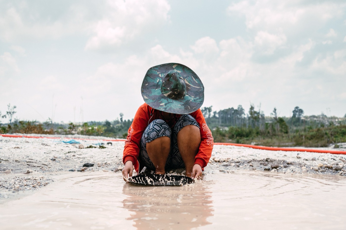 Panning for gold. Small scale miners produce a fifth of the world's gold, and most of the mercury in its rivers.