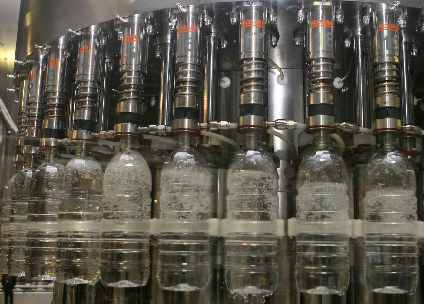 Bottled water on pallets. The product leaves the watershed by truck, which is what makes a bottling plant different from every other user.