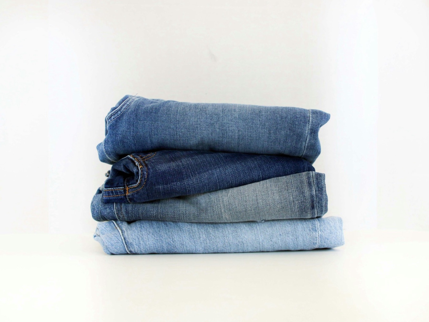 Denim in a stack. Close to a kilogram of cotton in every pair, and the field is where nearly all the water went.