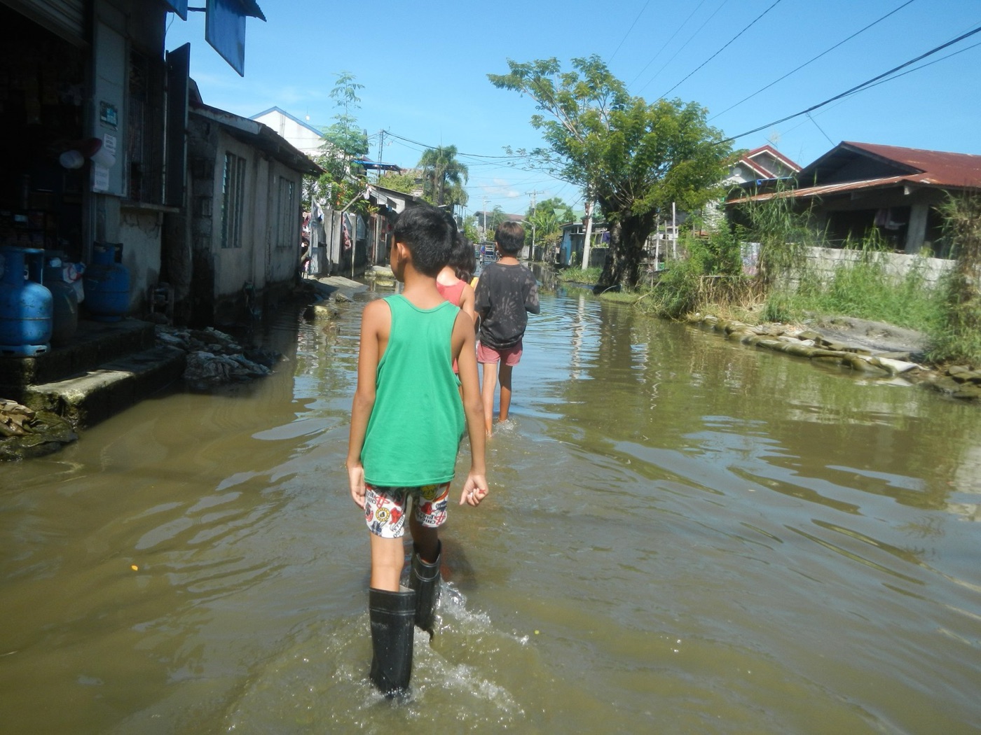 A street after a typhoon. The city floods in the wet season and is rationed by rota in the dry one.