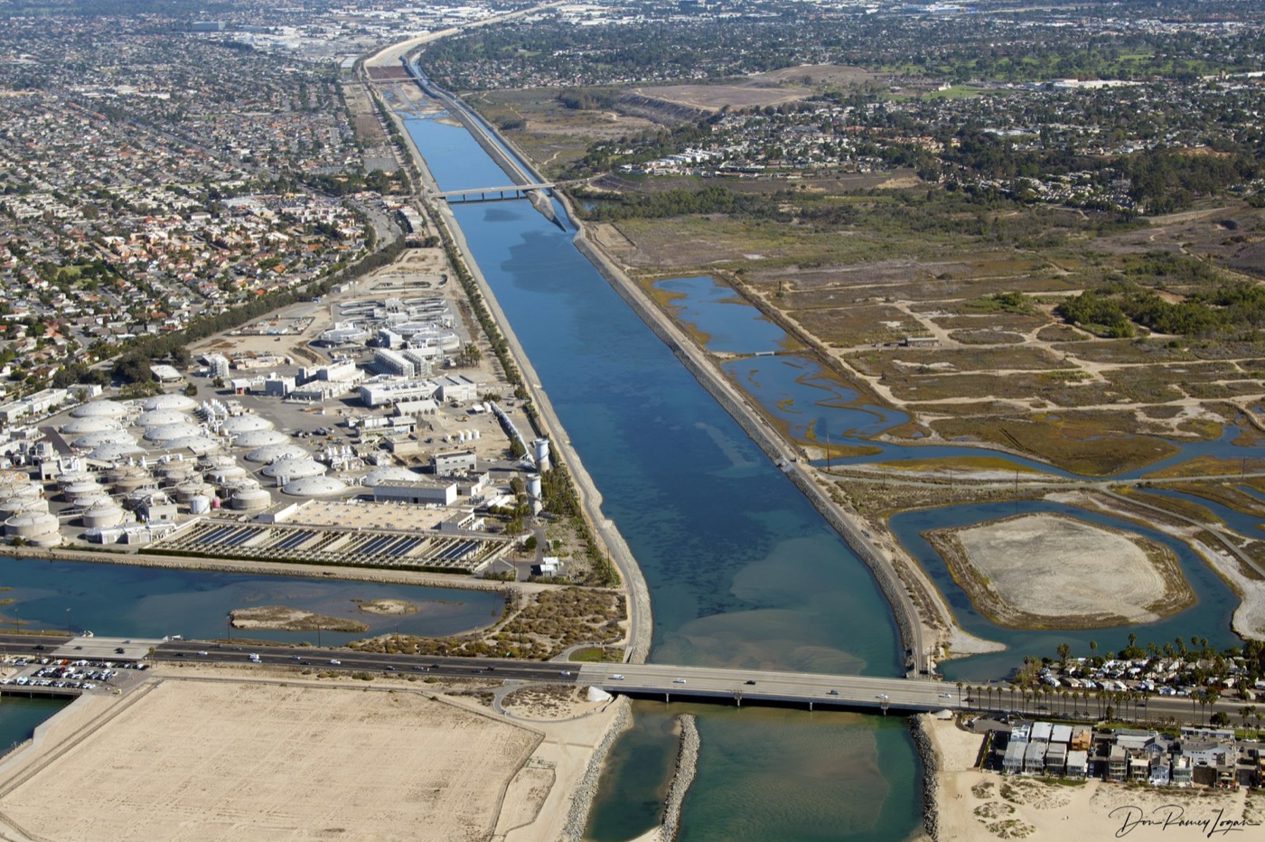 The Santa Ana River channel from the air, with the county's treatment works beside it.