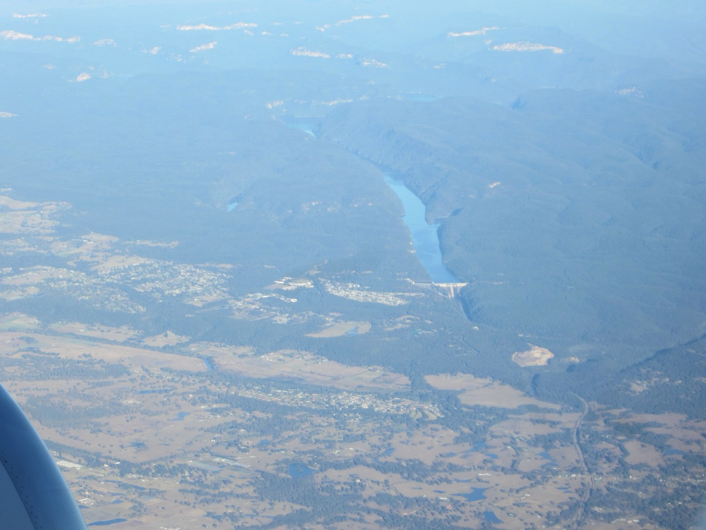 Warragamba from the air, with the suburbs of western Sydney beyond the ridge.