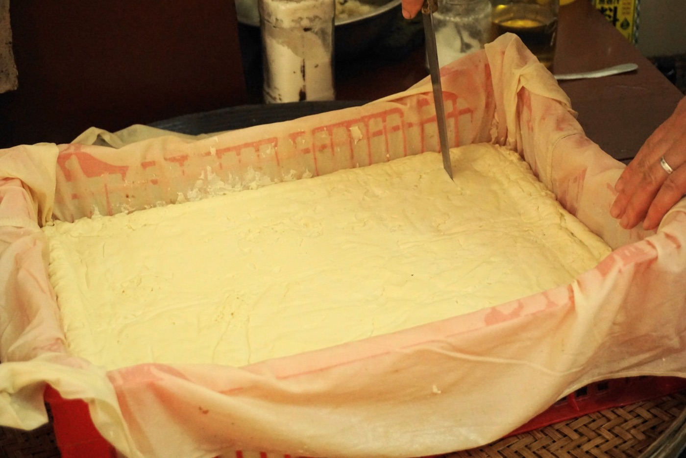 Tofu in the press. About seven percent of the world's soy is eaten as soy; the rest is fed to animals.