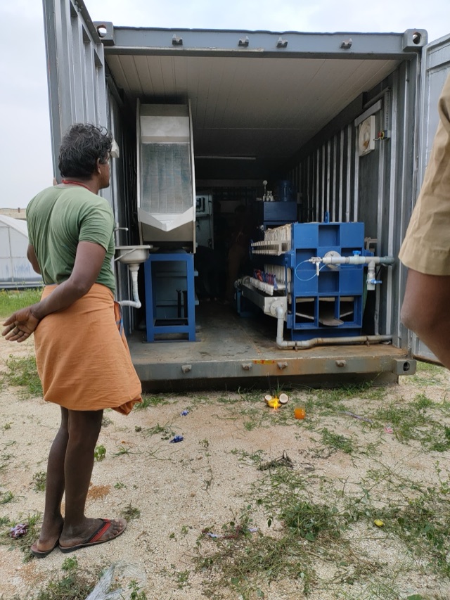 A blessing ceremony in front of a new treatment plant built inside a shipping container