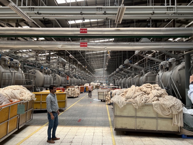 Rows of industrial dyeing machines in a large mill