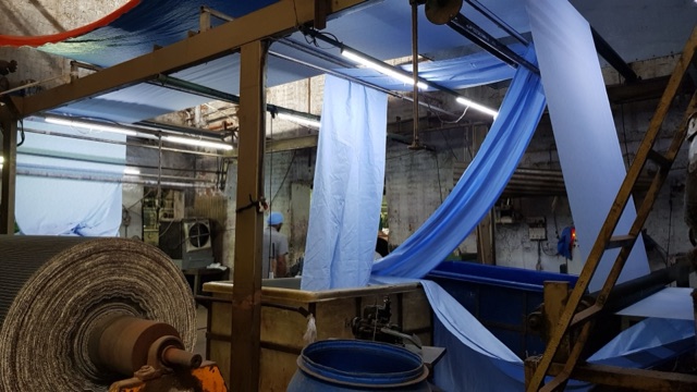 Blue fabric hanging in a dyehouse