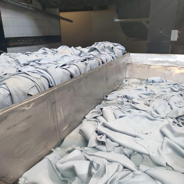 Wet hides soaking in a tannery vat